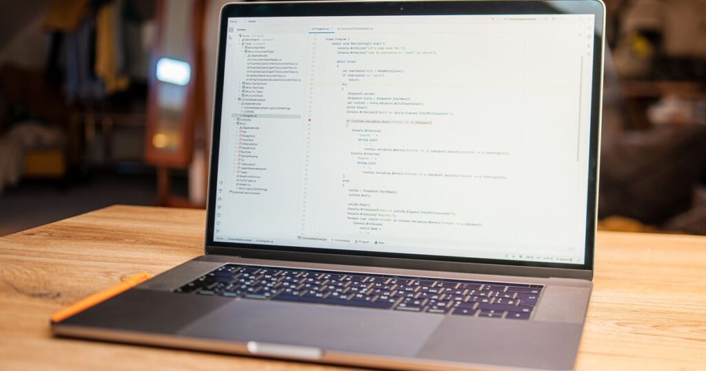 Laptop on a wooden desk showing code, representing testing a WordPress update